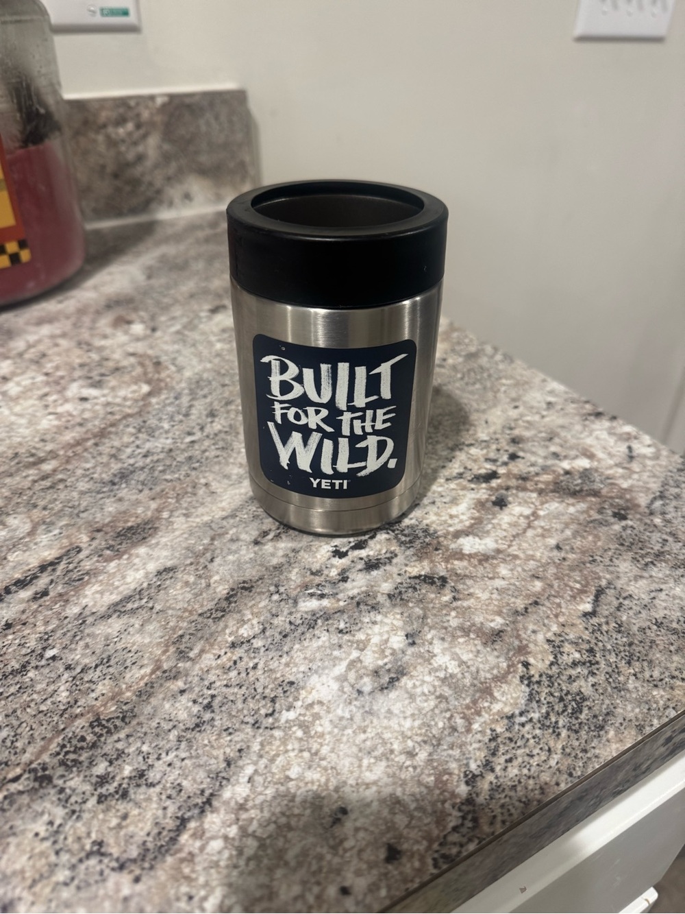 Yeti Silver Can Insulator with Black Rim and Navy Sticker